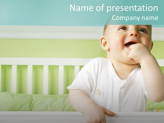 Baby Boy Smiling In Crib PowerPoint Template