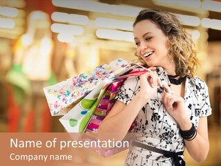 Photo Of Young Joyful Woman With Shopping Bags On The Background Of Shop Windows PowerPoint Template