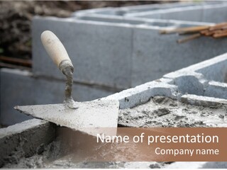 Closeup Of Mason's Trowel On Concrete Shuttering Blocks Filled With Mortar PowerPoint Template