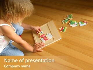 2-3 Years Old Girl Kneeling On The Floor And Solving Jigsaw Puzzle PowerPoint Template