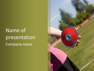 Discus In Hand With Athletic Field In Background PowerPoint Template