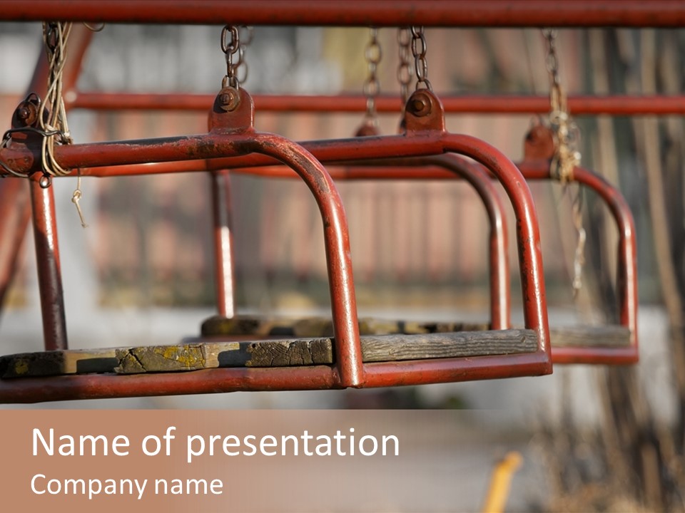 Closeup Of Aged Swings On A Playground PowerPoint Template