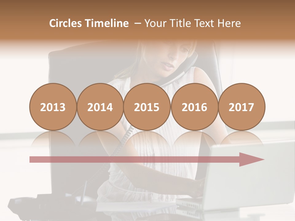 Businesswoman Sitting In Office With Laptop On Telephone PowerPoint Template