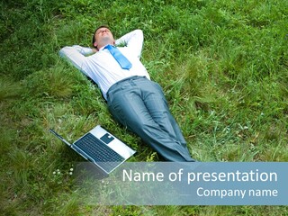 Image Of Businessman Relaxing On The Grass With Laptop Near By PowerPoint Template