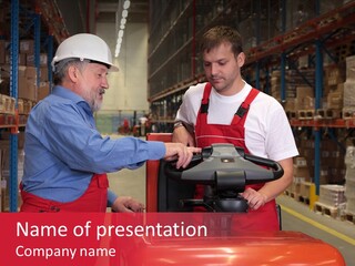 A Senior Worker Teaching His Junior The Operation Of A Fork Lift Vehicle In A Factory PowerPoint Template