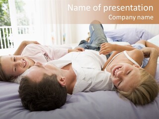 Man Lying In Bed With Two Young Girls Smiling PowerPoint Template