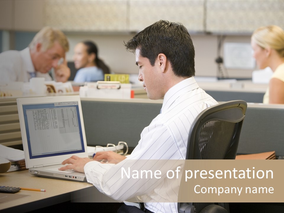 Businessman In Cubicle Using Laptop PowerPoint Template