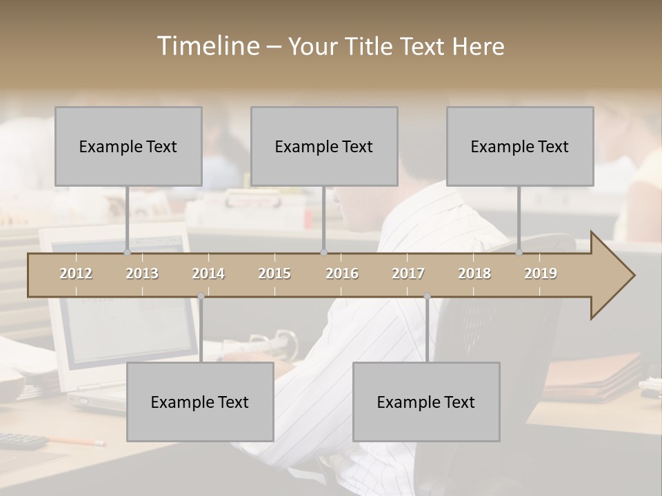 Businessman In Cubicle Using Laptop PowerPoint Template
