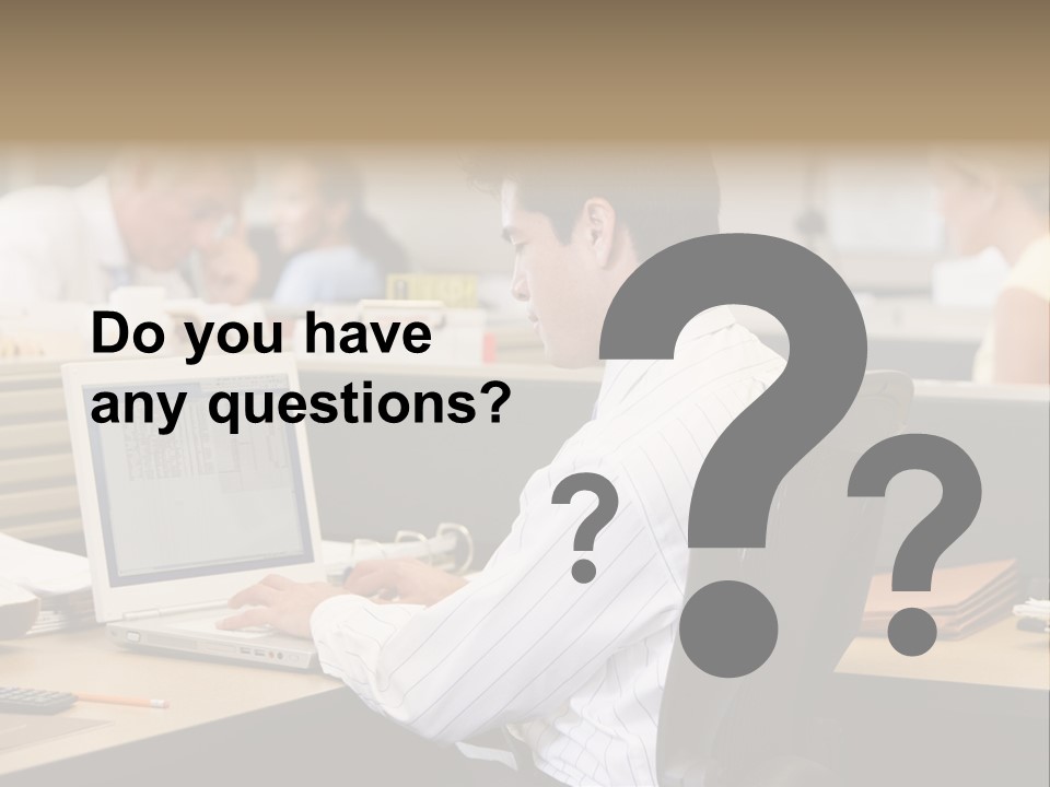 Businessman In Cubicle Using Laptop PowerPoint Template