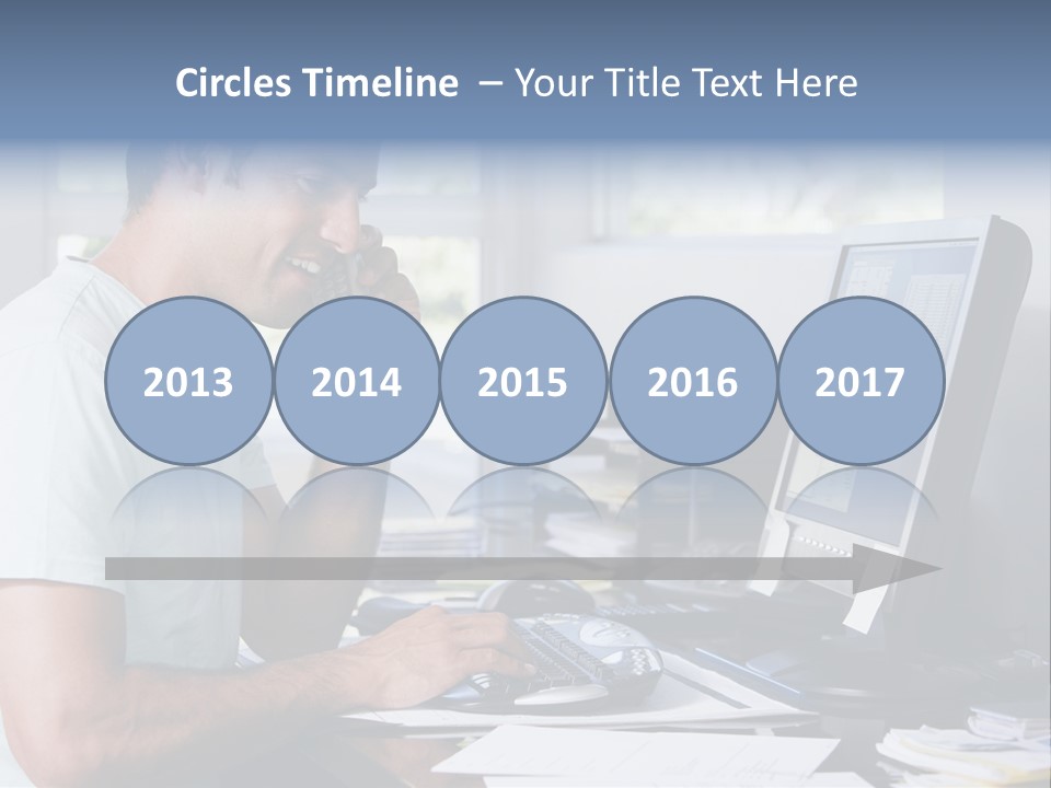 Man In Home Office On Telephone Using Computer And Smiling PowerPoint Template