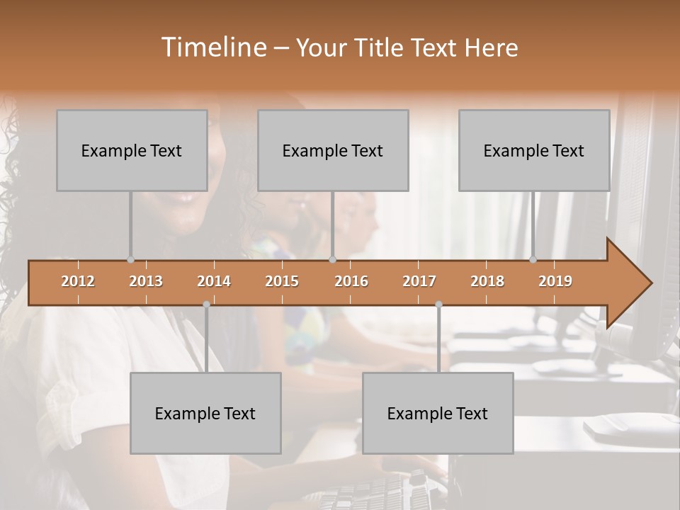 A Group Of People Sitting In Front Of Computers PowerPoint Template