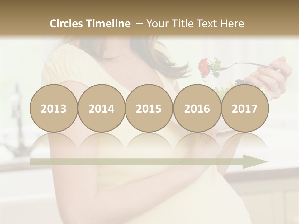 Pregnant Woman In Kitchen Eating A Salad Smiling PowerPoint Template