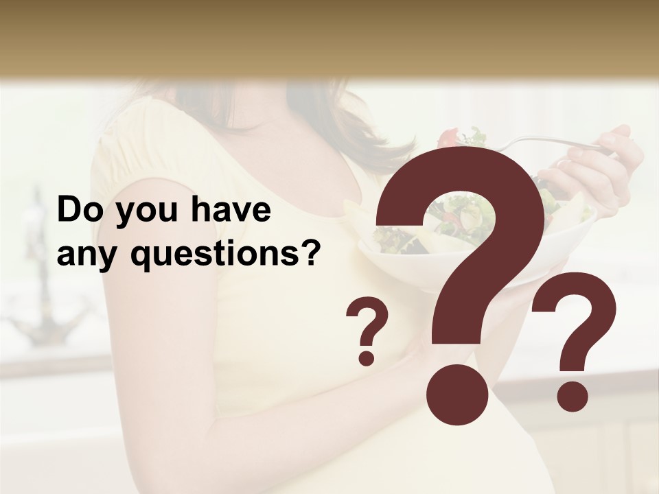 Pregnant Woman In Kitchen Eating A Salad Smiling PowerPoint Template