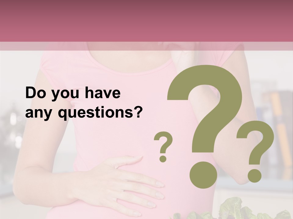 Pregnant Woman In Kitchen Making A Salad And Smiling PowerPoint Template