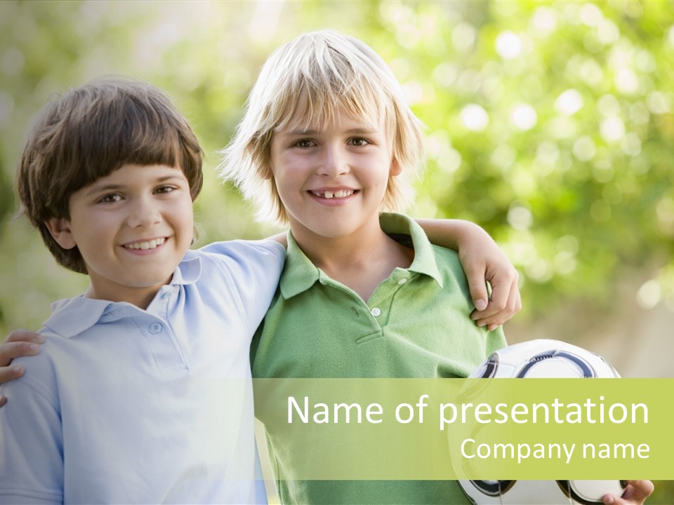 Two Young Boys Outdoors With Soccer Ball Smiling PowerPoint Template