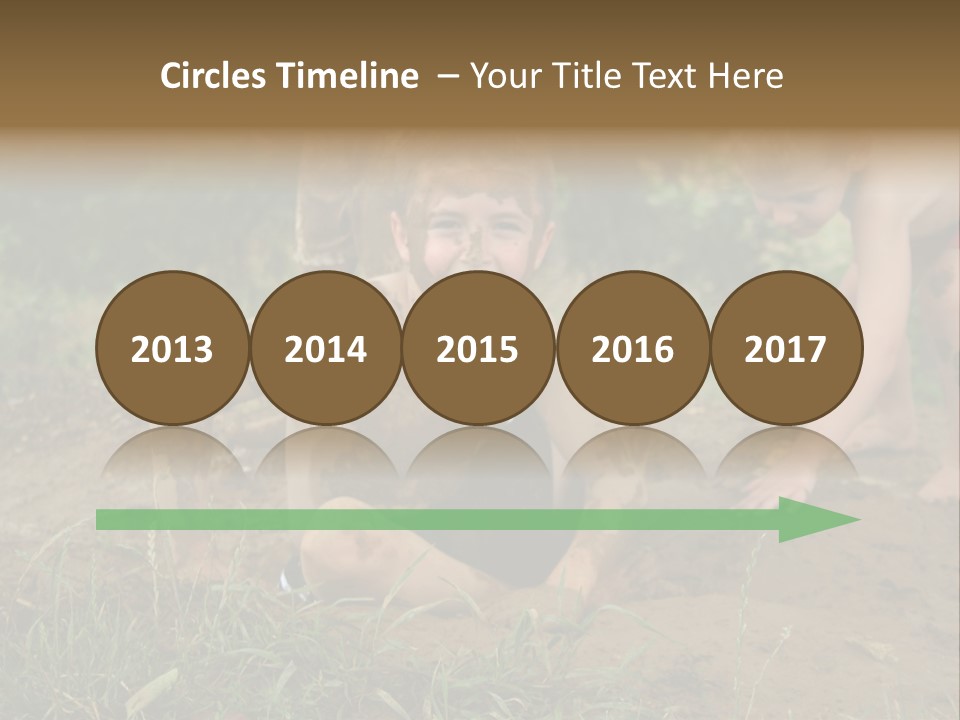 Boy Painted With Mud Sitting In Dirt Hole With Other Boys Playing In Background PowerPoint Template