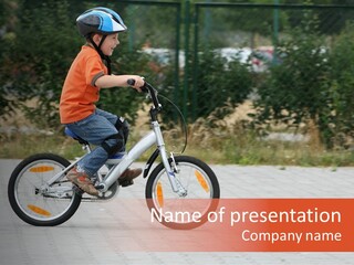 Boy Riding Bike In A Helmet PowerPoint Template