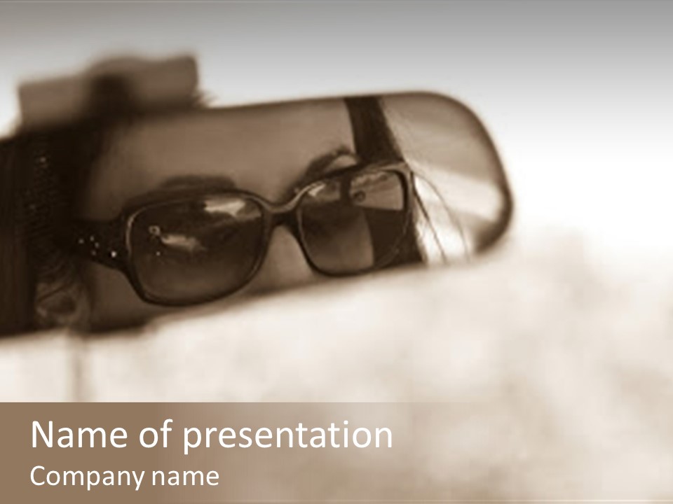 The Face Of A Young Woman Driving As Seen In The Rear View Mirror. PowerPoint Template