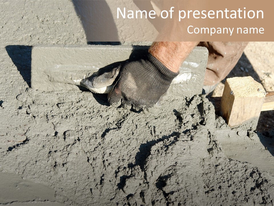 Closeup Of Mason's Hand Spreading Concrete Mix With Trowel In Foundation Shuttering PowerPoint Template