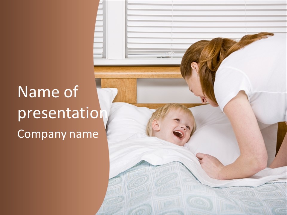 Devoted Mother Putting Talkative Son To Bed At Bedtime PowerPoint Template