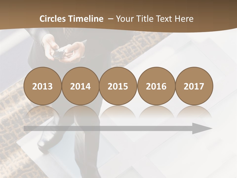 A Man In A Suit Is Looking Down At His Cell Phone PowerPoint Template