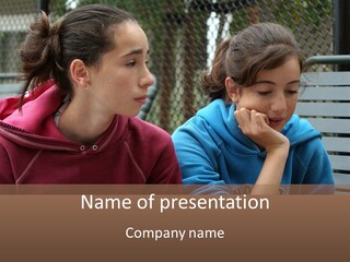 Two Young Girls Sitting On A Bench Looking At Something PowerPoint Template