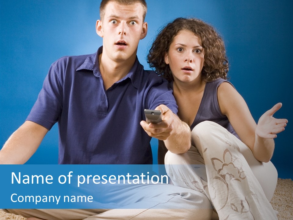 Young Couple On Beige Carpet With Remote Control - Shocked Faces PowerPoint Template