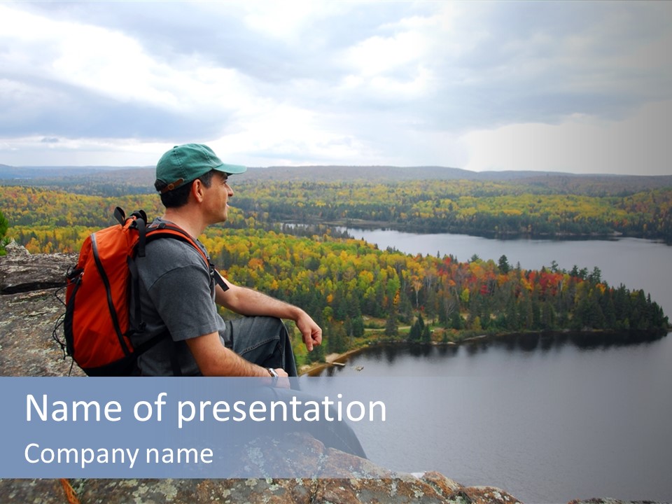 A Hiker Sitting On A Cliff Edge Enjoying Scenic View PowerPoint Template