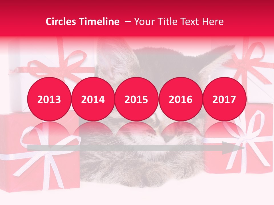 A Kitten Sleeping Next To A Pile Of Wrapped Presents PowerPoint Template