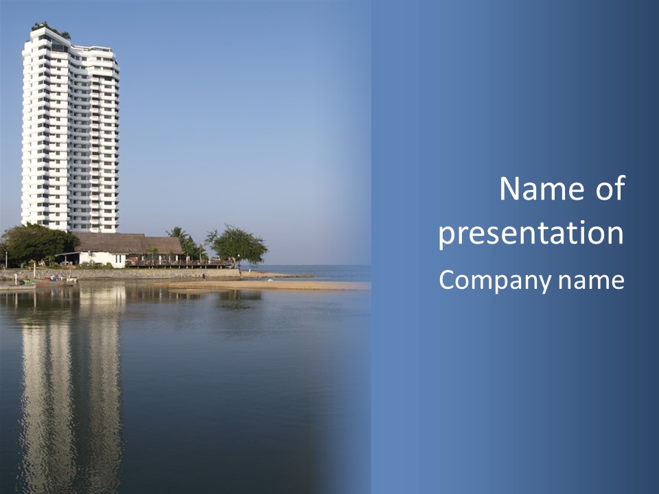 A Large White Building Sitting Next To A Body Of Water PowerPoint Template