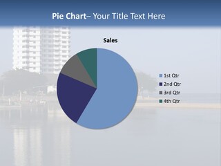 A Large White Building Sitting Next To A Body Of Water PowerPoint Template