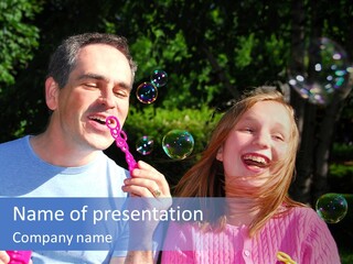 Father And Daughter Blowing Soap Bubbles Together PowerPoint Template