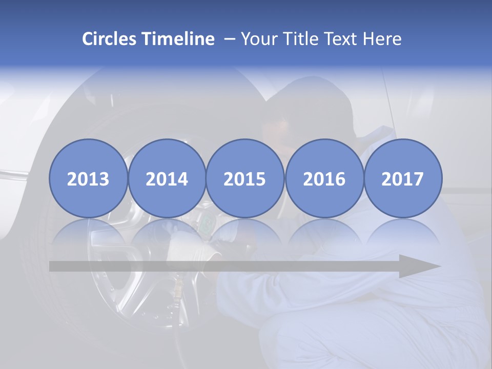 Auto Mechanic Removing Wheel Of A Car In A Workshop PowerPoint Template