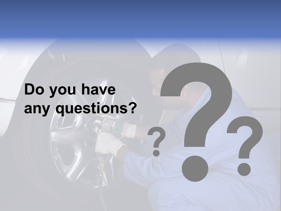 Auto Mechanic Removing Wheel Of A Car In A Workshop PowerPoint Template