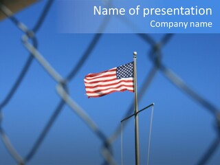 American Flag Behind A Chain Link Fence. PowerPoint Template