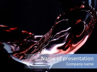 Closeup Of Red Wine Pouring In A Glass Isolated On Black Background PowerPoint Template
