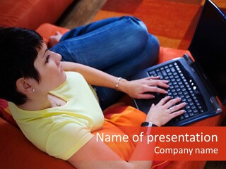 A Woman Sitting On A Couch Using A Laptop Computer PowerPoint Template