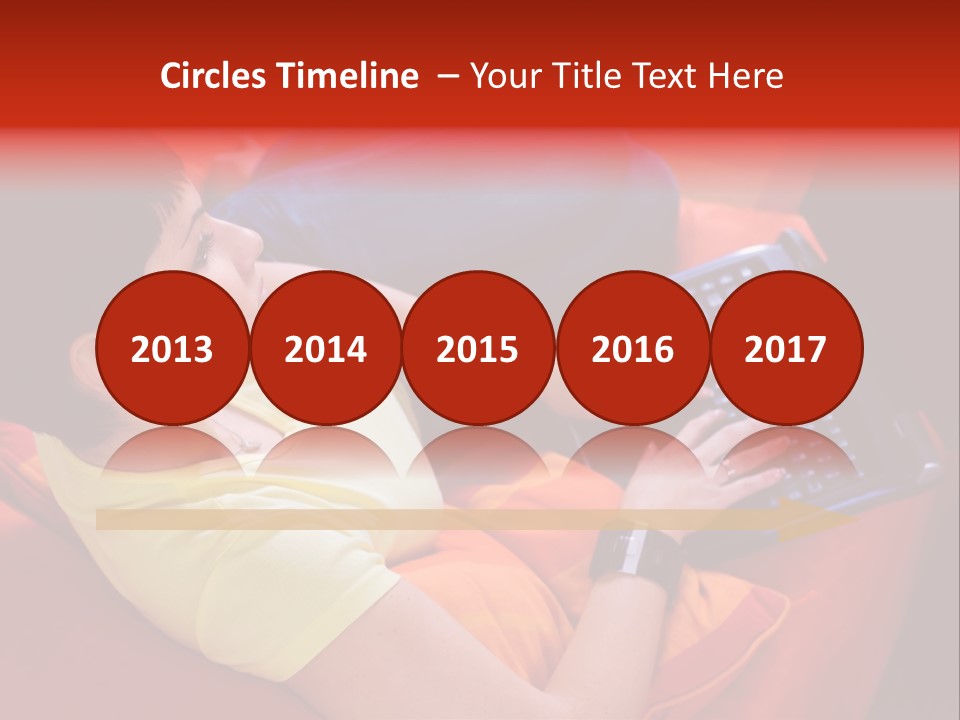 A Woman Sitting On A Couch Using A Laptop Computer PowerPoint Template