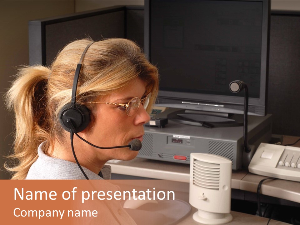 A Woman With A Headset Is Sitting In Front Of A Computer PowerPoint Template