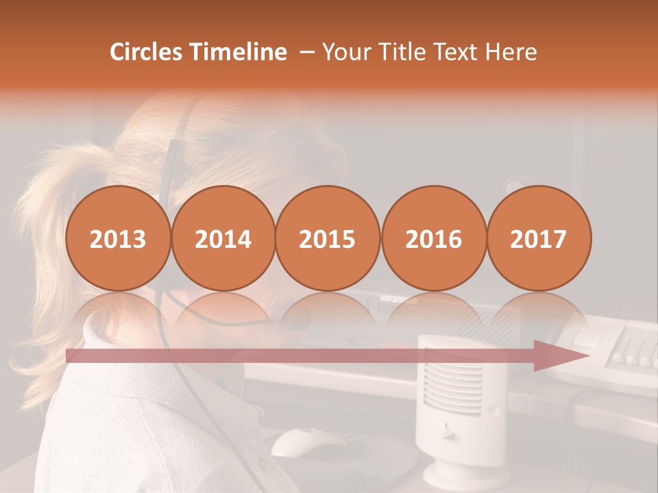 A Woman With A Headset Is Sitting In Front Of A Computer PowerPoint Template