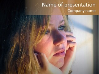 A Woman Looking Out A Window With Her Hand On Her Face PowerPoint Template