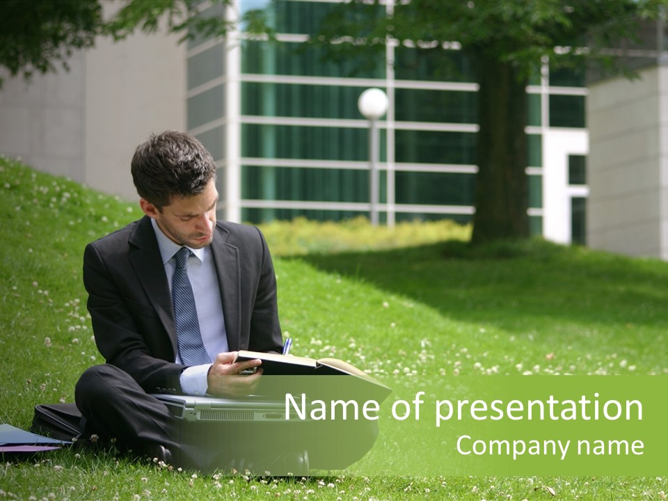 Business Man With Laptop And Notebook Working In The Park In Front Of Office Building PowerPoint Template