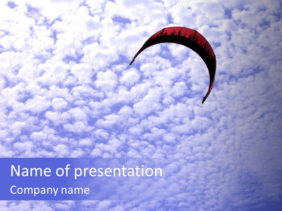 A Kite Surfers Kite Flying In A Cloudy Sky PowerPoint Template