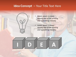 A Pretty Librarian In Her Wheelchair Shelving Books. PowerPoint Template