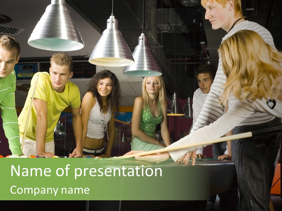 Large Group Of Teenagers Standing At Pool Table. Smiling And Looking At Right. One Person Is Playing Billard PowerPoint Template