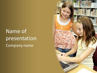 Two Cute School Girls Doing Research On-Line In The School Library. Focus On The Girl Sitting Down. PowerPoint Template