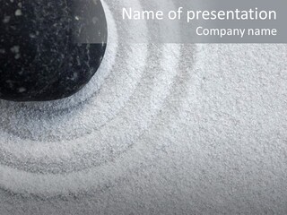 A Black Stone On A Wave Of White Sand In A Zen Garden PowerPoint Template