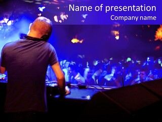 A Dj Performing In Front Of A Crowd Of People PowerPoint Template