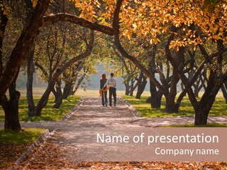 Autumn In Public Garden. Young Couple On A Path PowerPoint Template