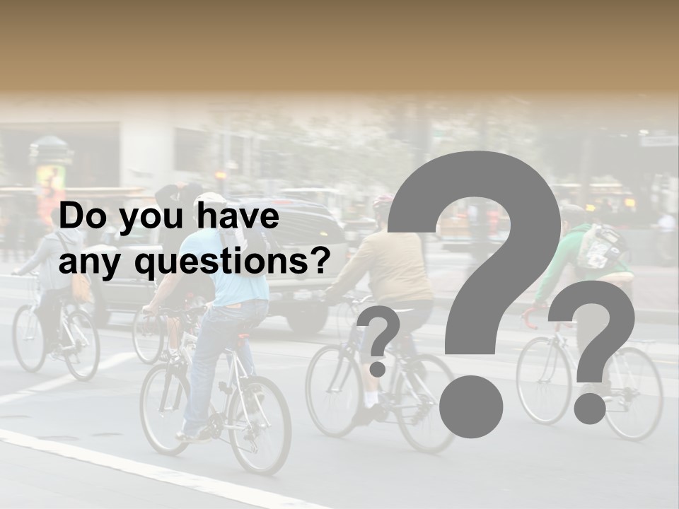 A Group Of People Riding Bikes Down A Street PowerPoint Template